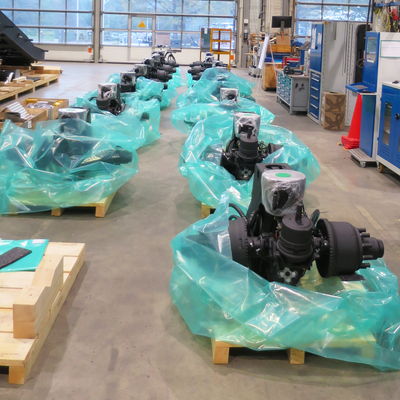 Essieux emballés pour véhicules de défense DOLL sur des palettes dans un atelier.